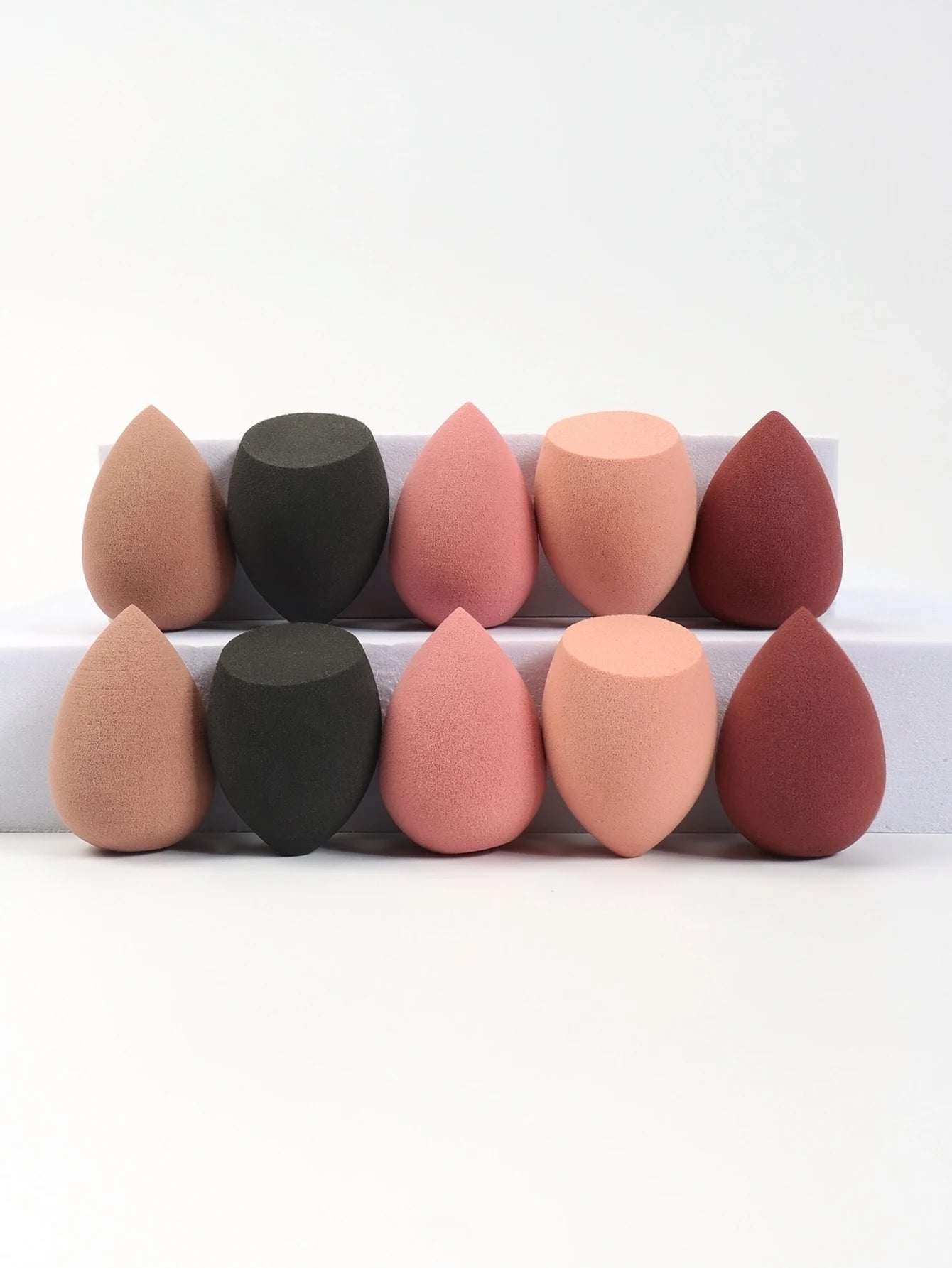 Set of 10 mini makeup sponges by amzzonstore, perfect for applying powder, foundation, and concealer smoothly on the face.