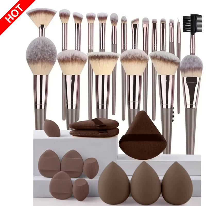 Set of professional makeup brushes including foundation, eyeshadow, concealer, blush, and kabuki brushes in soft, fluffy bristles.