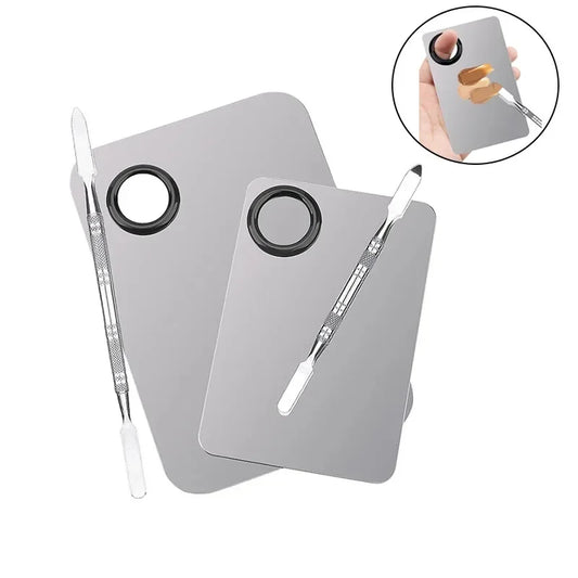 Stainless steel makeup mixing palette with spatula and mixing stick for foundation, lipstick, eyeshadow application.