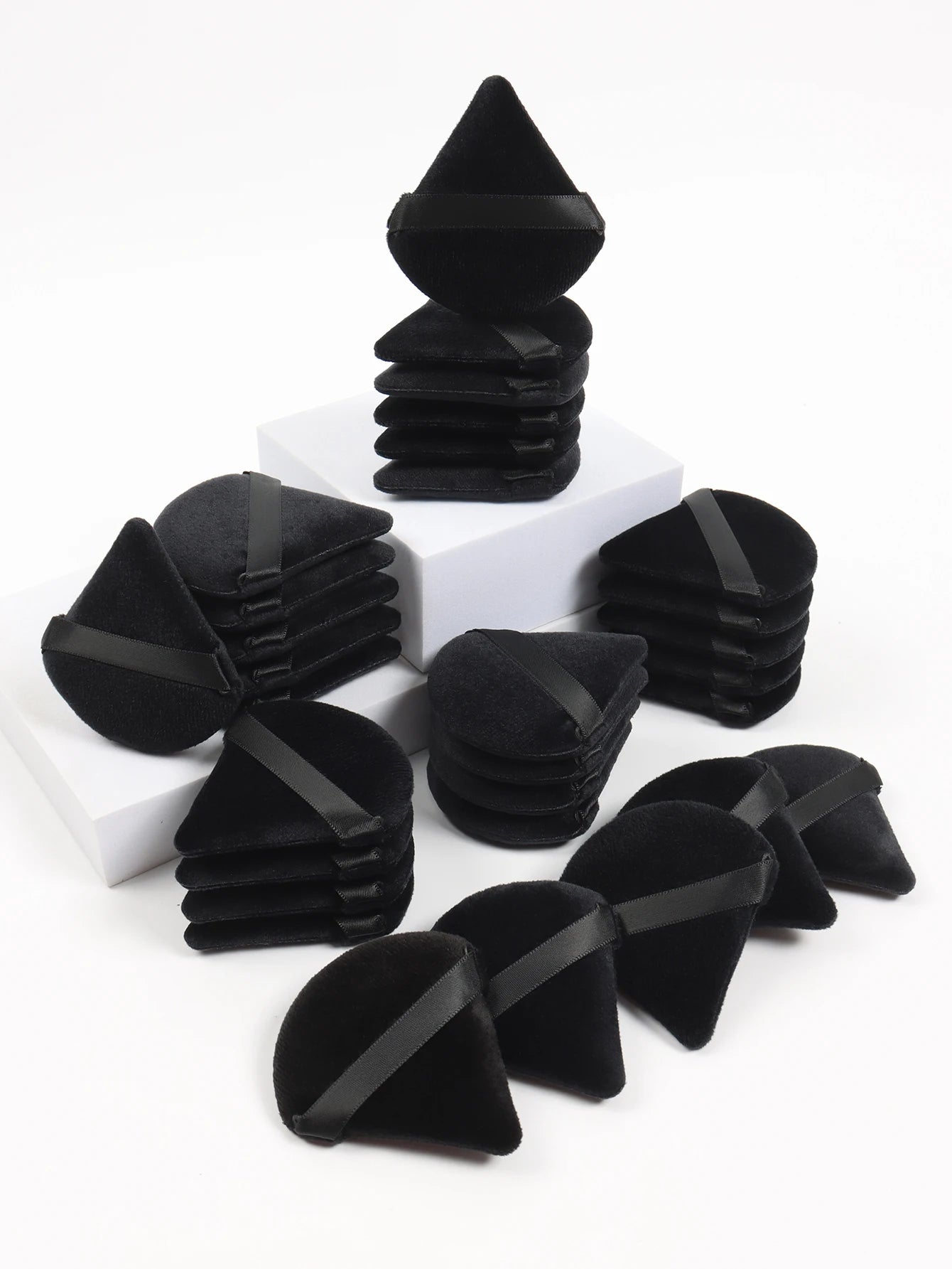 Black triangle makeup sponge by amzzonstore, soft velvet cosmetic puff for blending foundation and facial makeup.