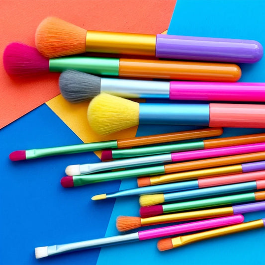 Set of 15 colorful makeup brushes including foundation, blush, concealer, eyeshadow, and blending brushes for professional makeup application.