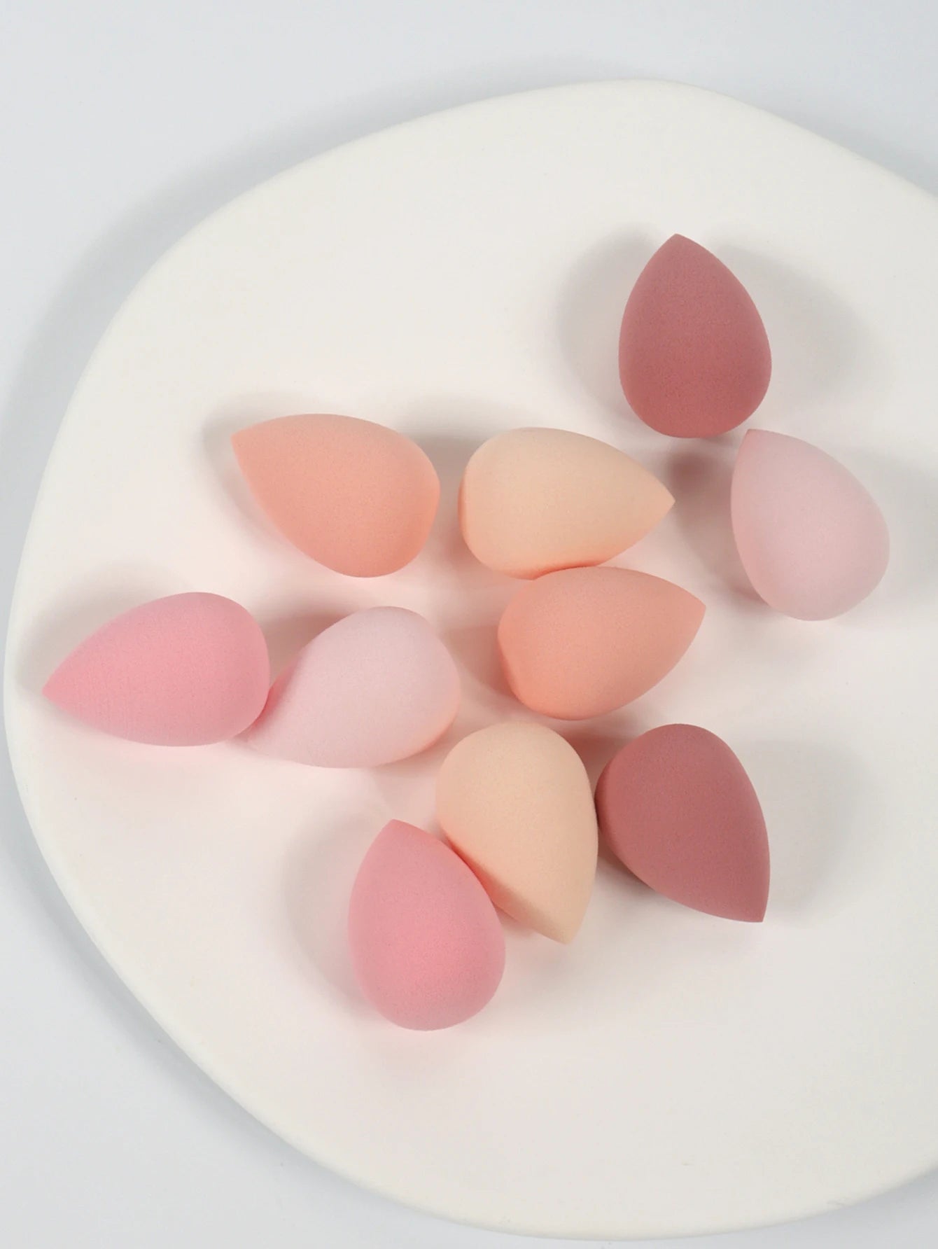 Set of 10 mini makeup sponges by amzzonstore, soft cosmetic powder puffs for applying foundation, concealer, and liquid makeup.