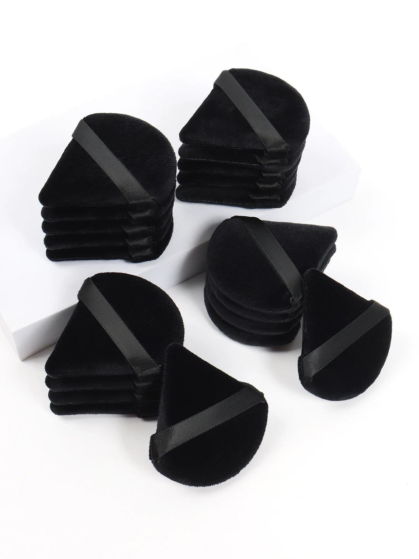 Black triangle powder puff by amzzonstore, soft velvet makeup sponge for foundation and beauty application, versatile cosmetic tool.