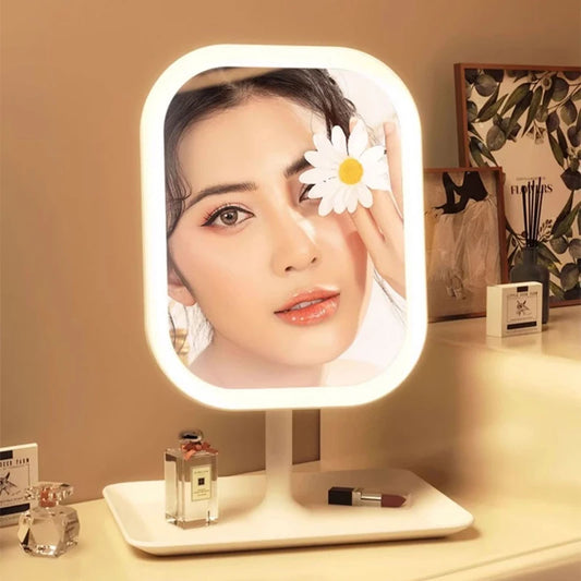Makeup mirror with LED lights on a desk with decorative items.