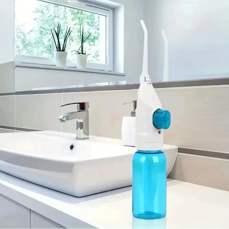 Portable manual water flosser and high pressure oral irrigator in black
